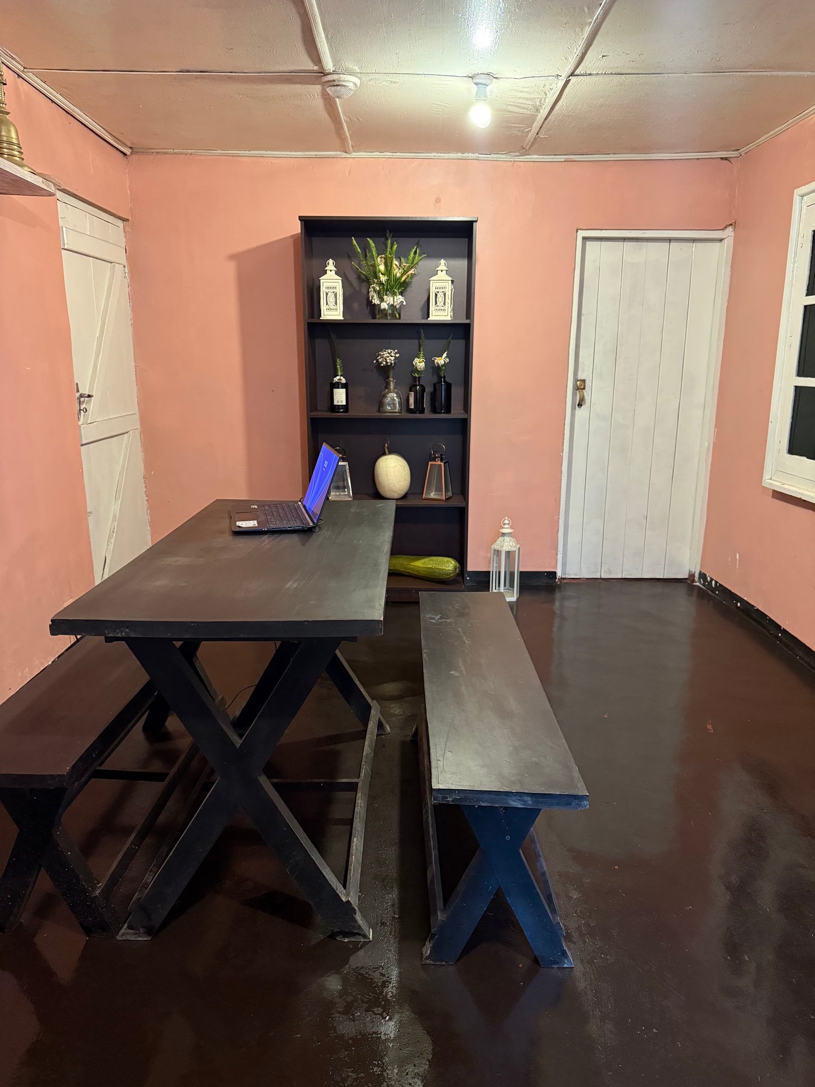 The dining room with a long wooden table and benches