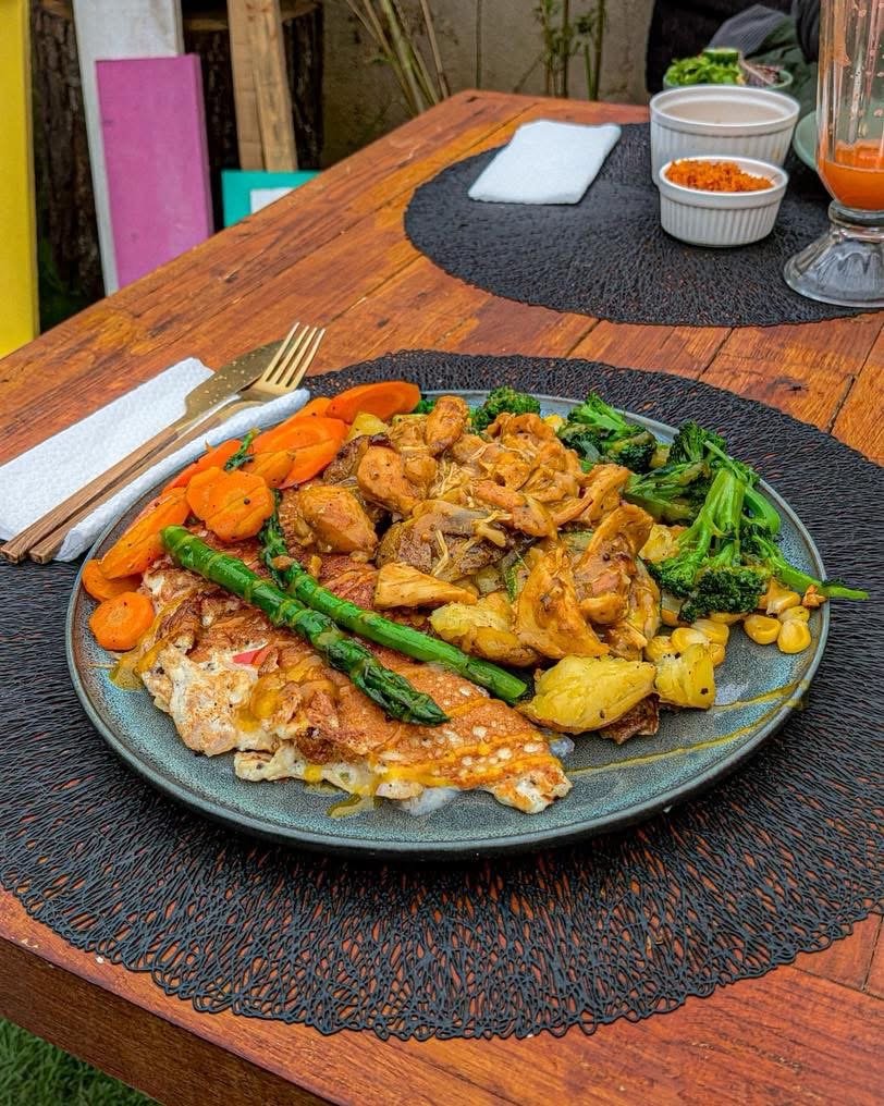 A plate of chicken with roasted garden vegetables