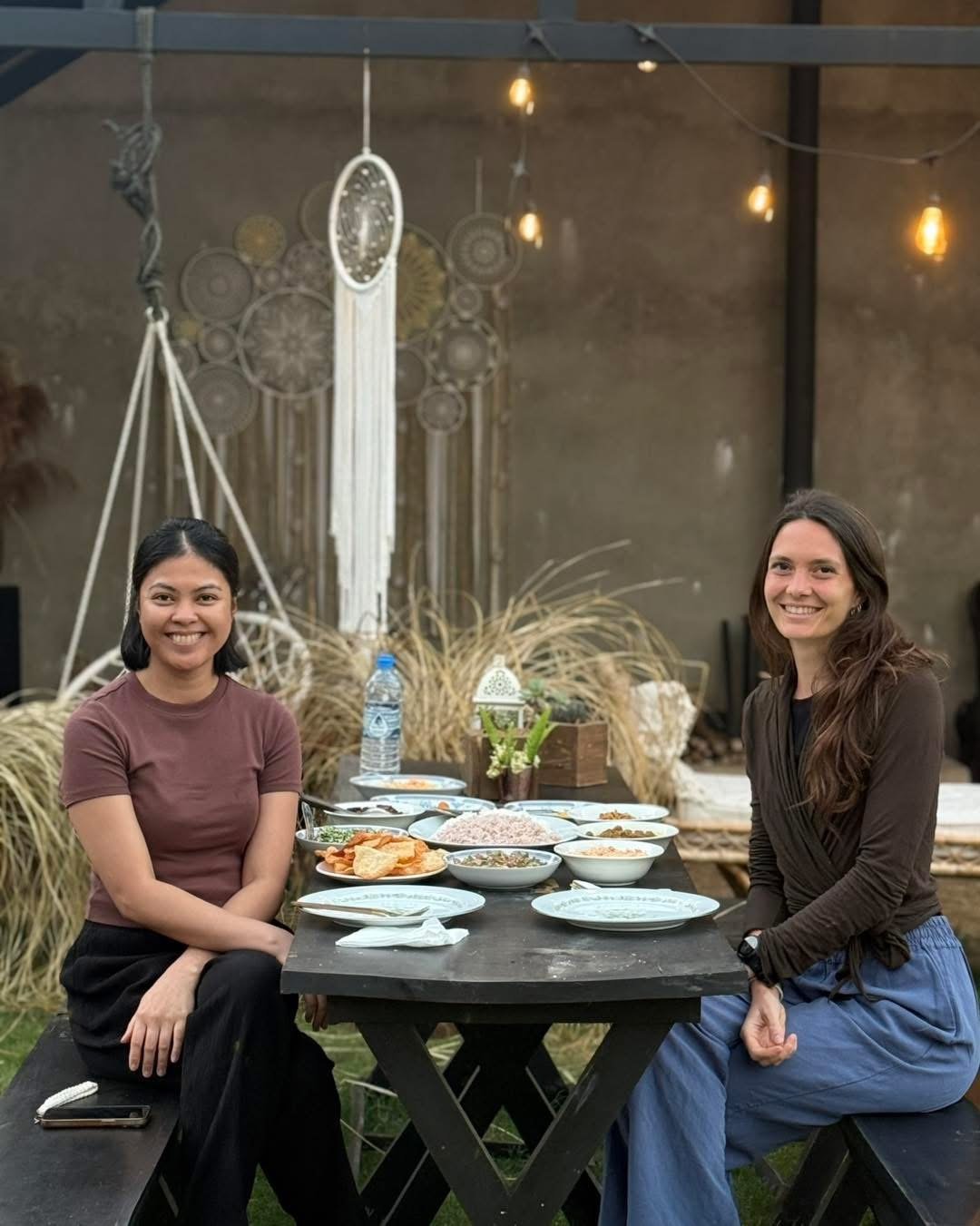 Two guests at a table set with tea and small plates