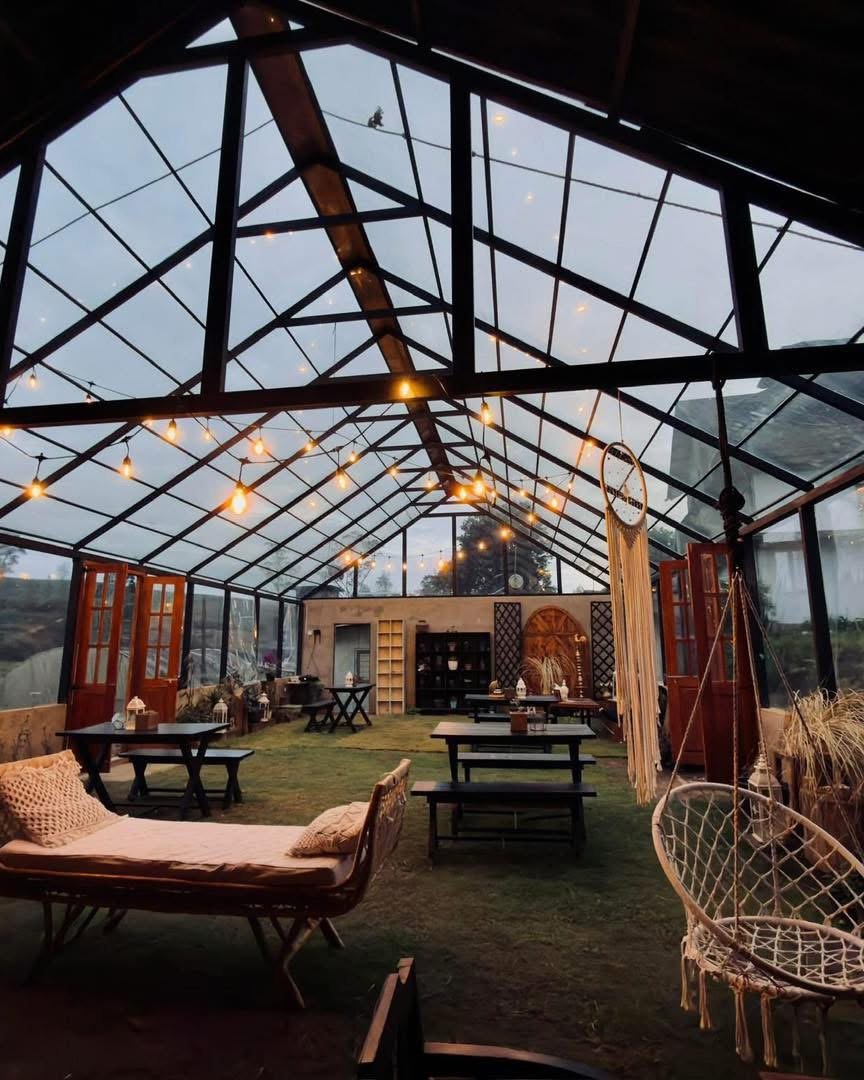 The greenhouse at dusk, lit with string lights