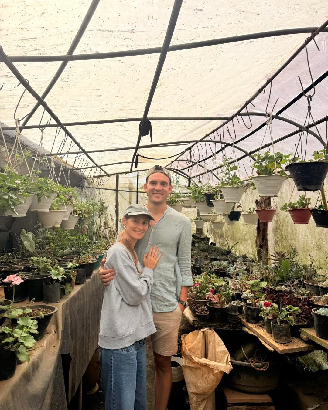 Two guests among the potted plants in the greenhouse