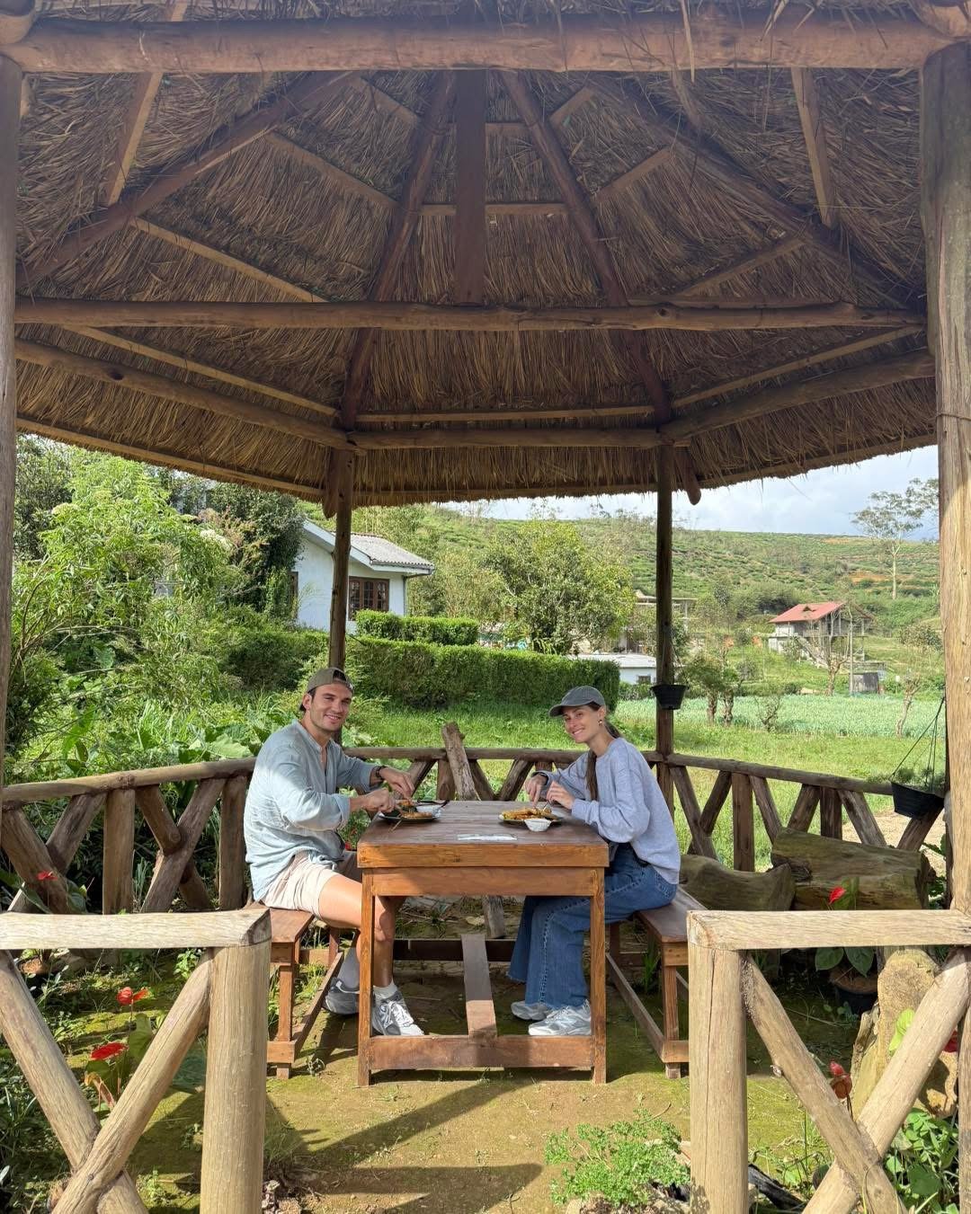 Two guests sharing a table in the gazebo above the valley